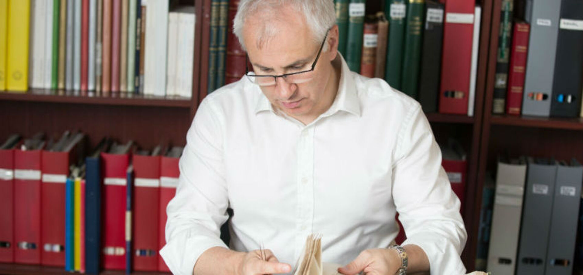 Vincent Green, chairman of Sandafayre, analysing stamp collections