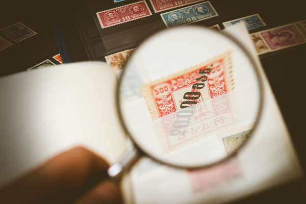 The team of experts at Sandafayre analysing a stamp collection