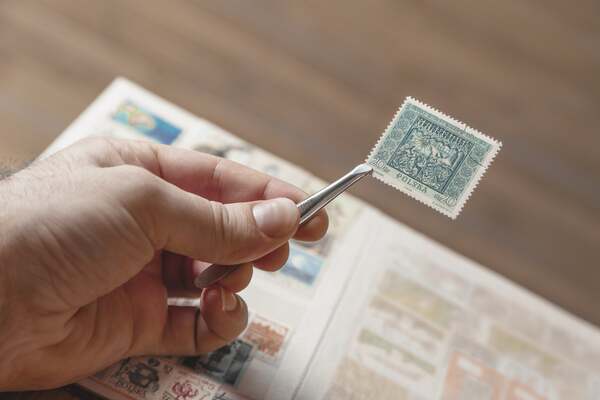 Stamp expert at Sandafayre analysing an interesting stamp from a collection